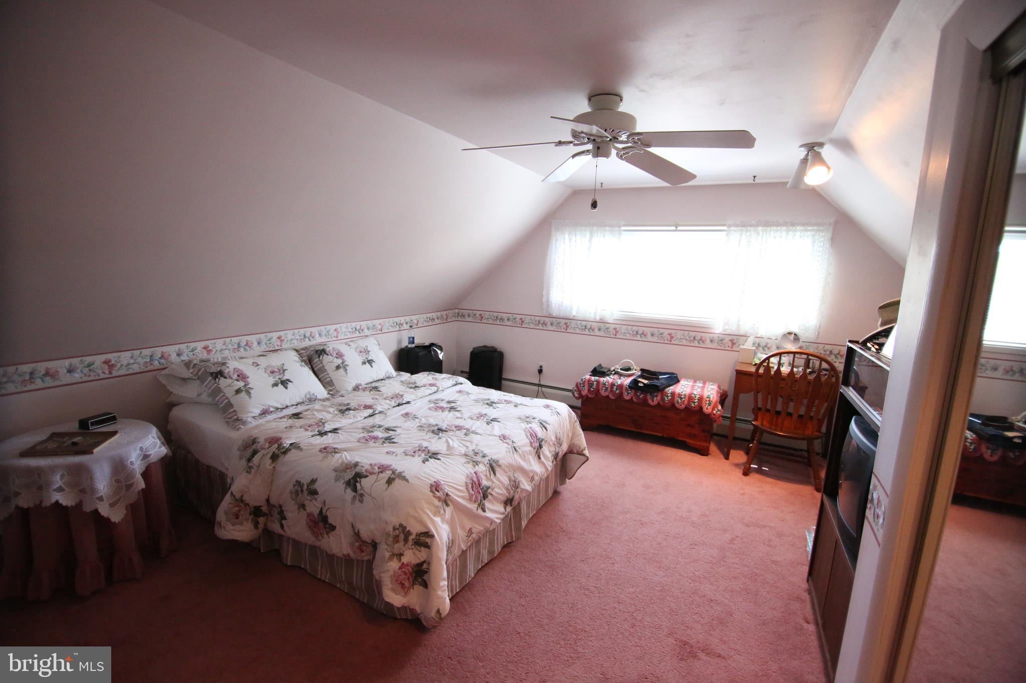 47 Trellis Road Levittown, PA 19056 - Photo 18 of 34 a bed sitting in a bedroom next to a window