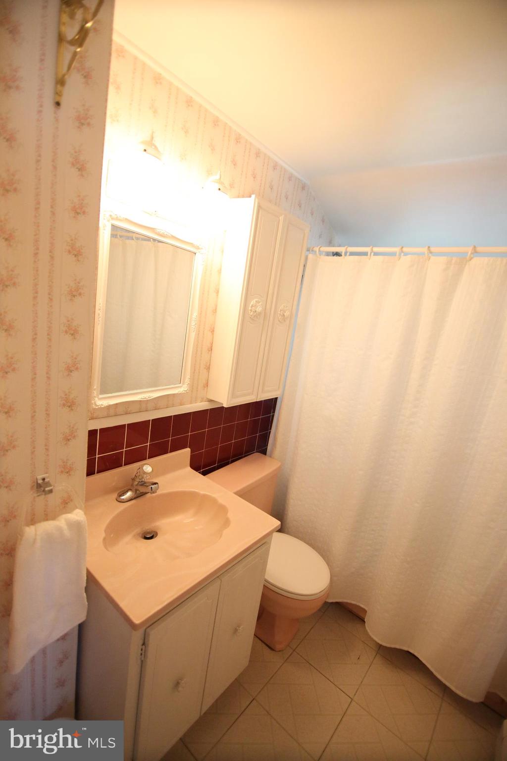 47 Trellis Road Levittown, PA 19056 - Photo 19 of 34 a bathroom with a sink and a mirror