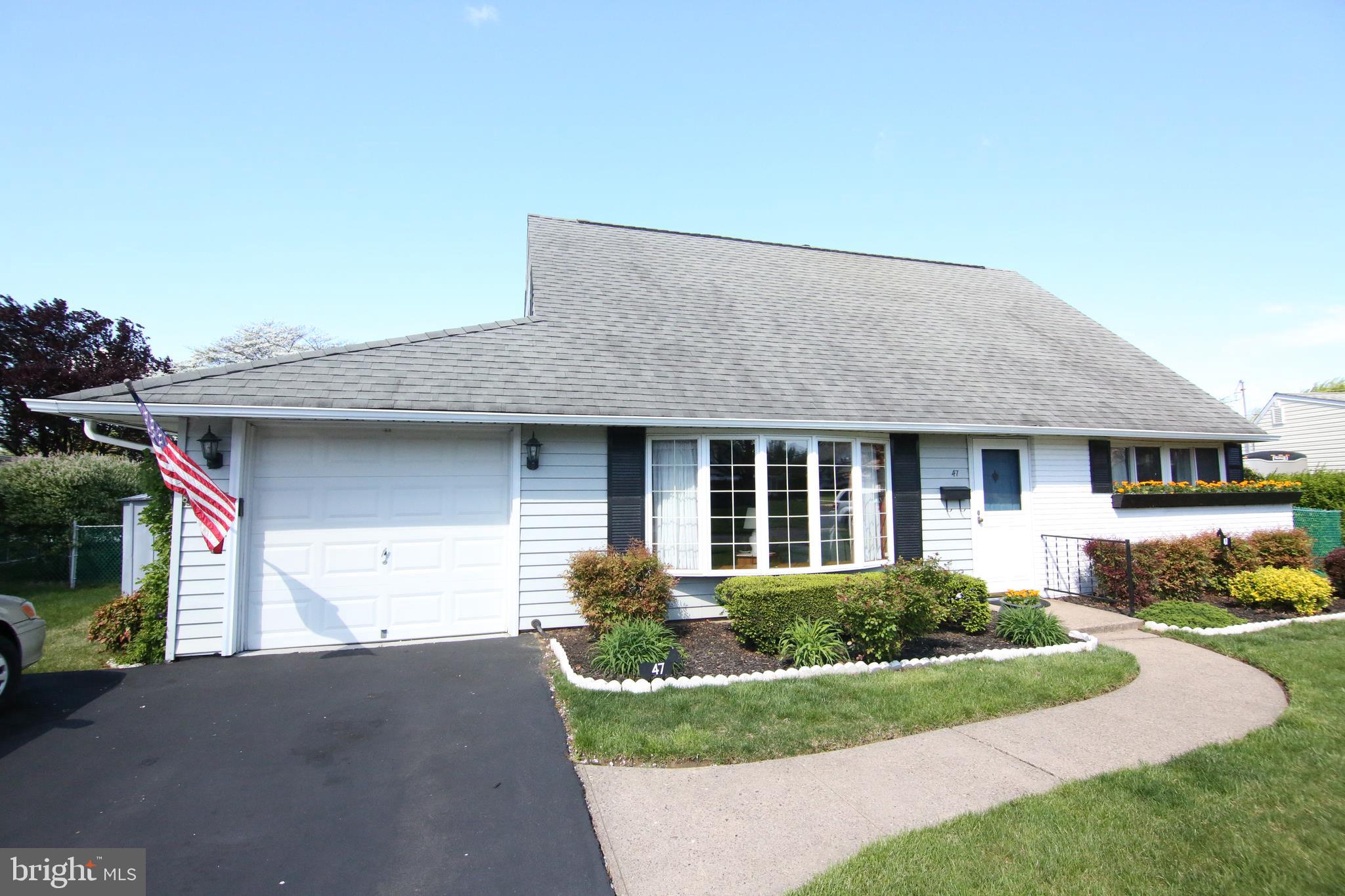 47 Trellis Road Levittown, PA 19056 - Photo 3 of 34 a front view of a house with a yard and potted plants