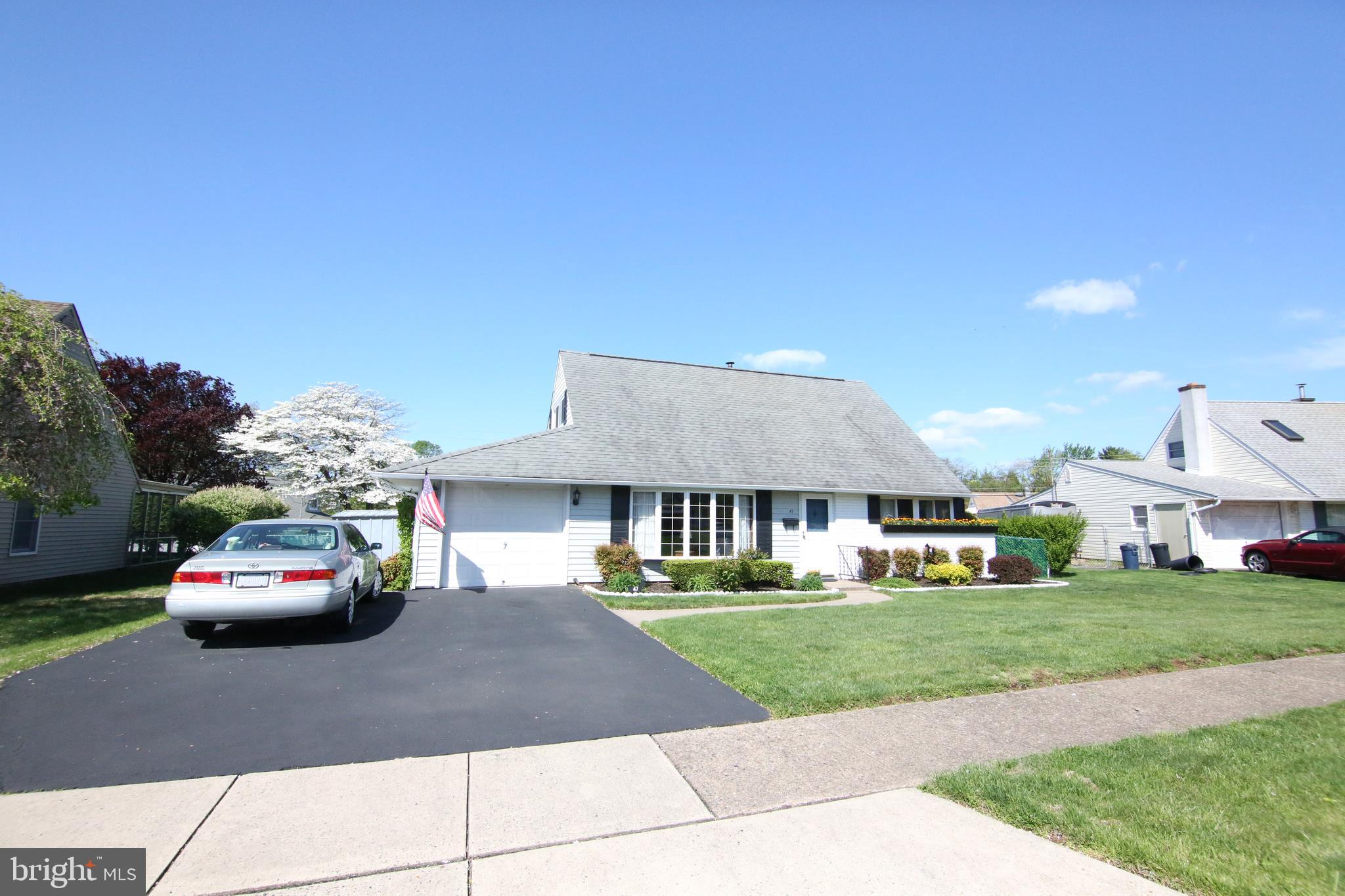 47 Trellis Road Levittown, PA 19056 - Photo 4 of 34 a front view of a house with a garden and parking space