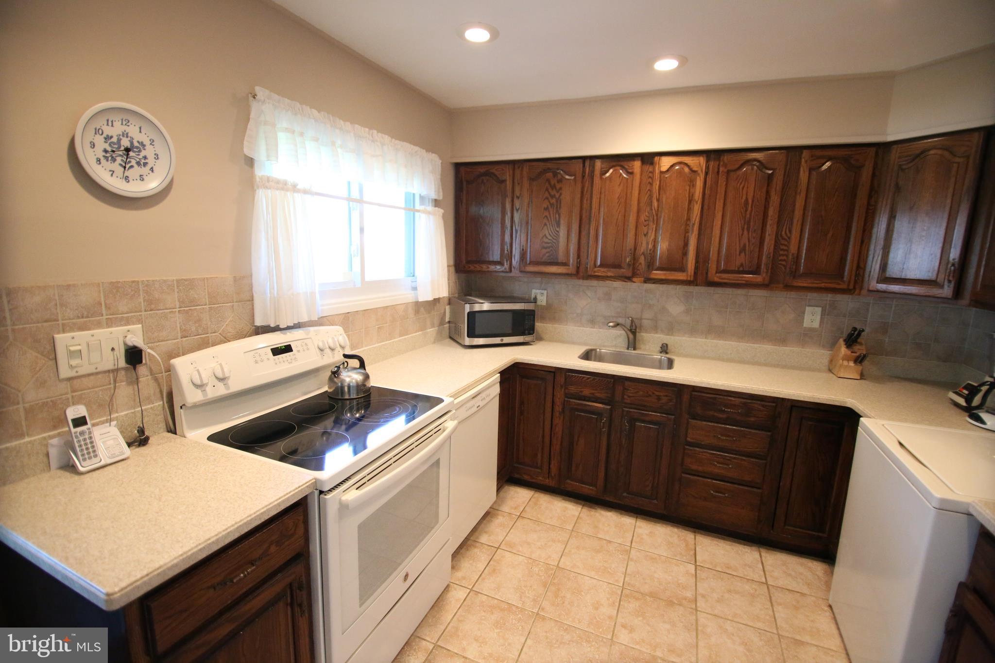 47 Trellis Road Levittown, PA 19056 - Photo 5 of 34 a kitchen with a stove cabinets and window
