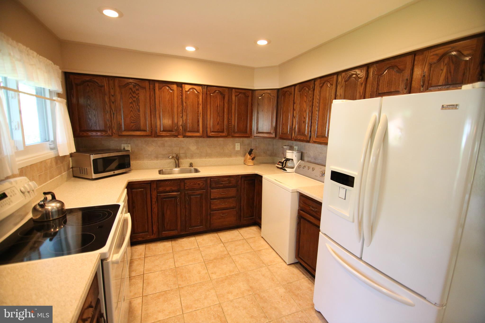 47 Trellis Road Levittown, PA 19056 - Photo 6 of 34 a kitchen with a refrigerator sink and cabinets