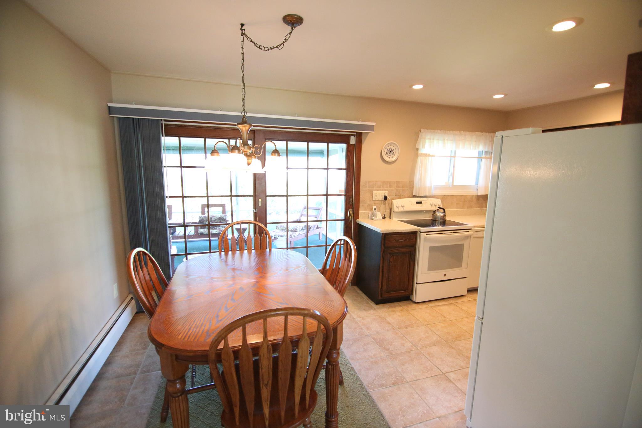 47 Trellis Road Levittown, PA 19056 - Photo 10 of 34 a dining room with furniture a chandelier and wooden floor