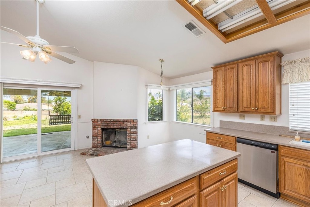 44194 Meadow Grove Street Hemet, CA 92544 - Photo 11 of 42 a kitchen with a stove a sink a counter space and a fireplace