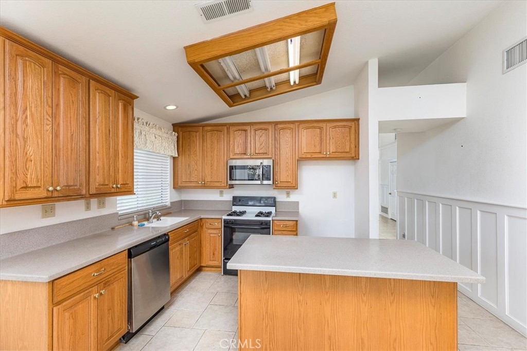 44194 Meadow Grove Street Hemet, CA 92544 - Photo 12 of 42 a kitchen with stainless steel appliances granite countertop a sink stove and refrigerator