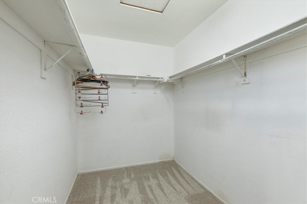 44194 Meadow Grove Street Hemet, CA 92544 - Photo 20 of 42 a view of walk in closet with empty racks
