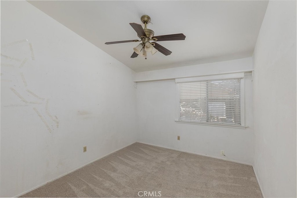 44194 Meadow Grove Street Hemet, CA 92544 - Photo 25 of 42 an empty room with a window and a ceiling fan