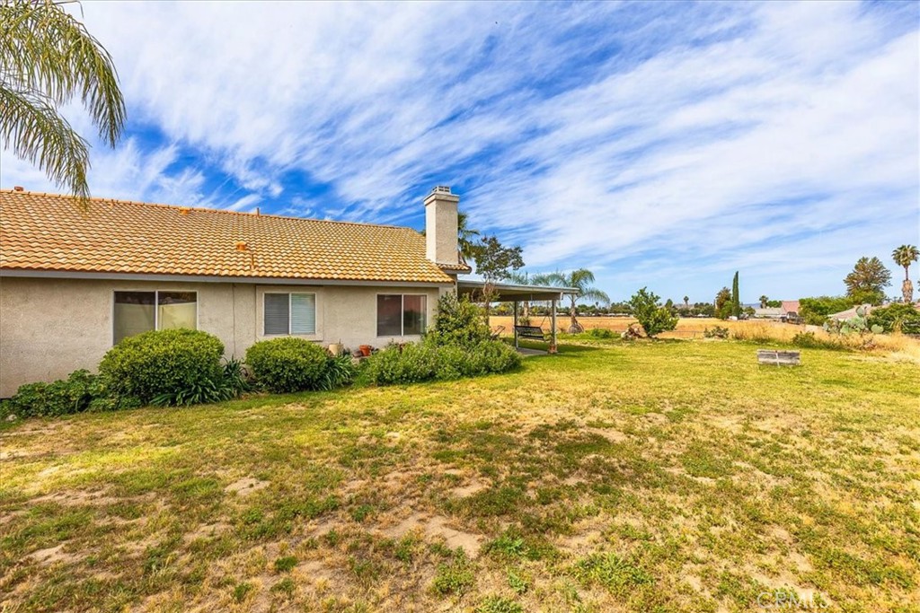 44194 Meadow Grove Street Hemet, CA 92544 - Photo 30 of 42 a front view of house with yard and trees