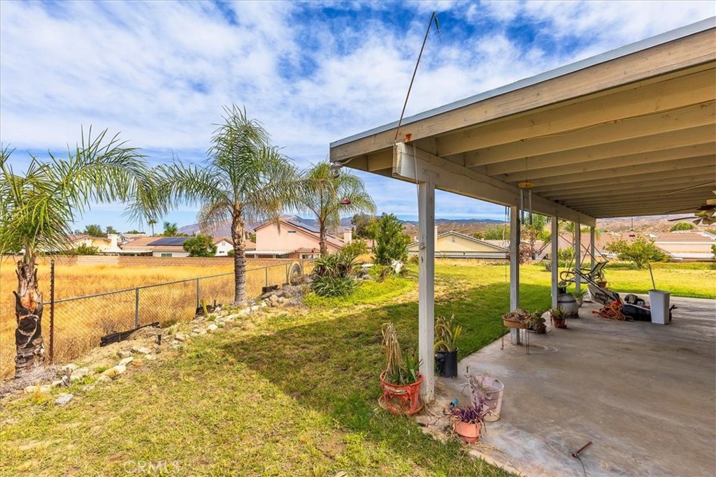 44194 Meadow Grove Street Hemet, CA 92544 - Photo 33 of 42 a view of a swimming pool with lawn chairs under an umbrella