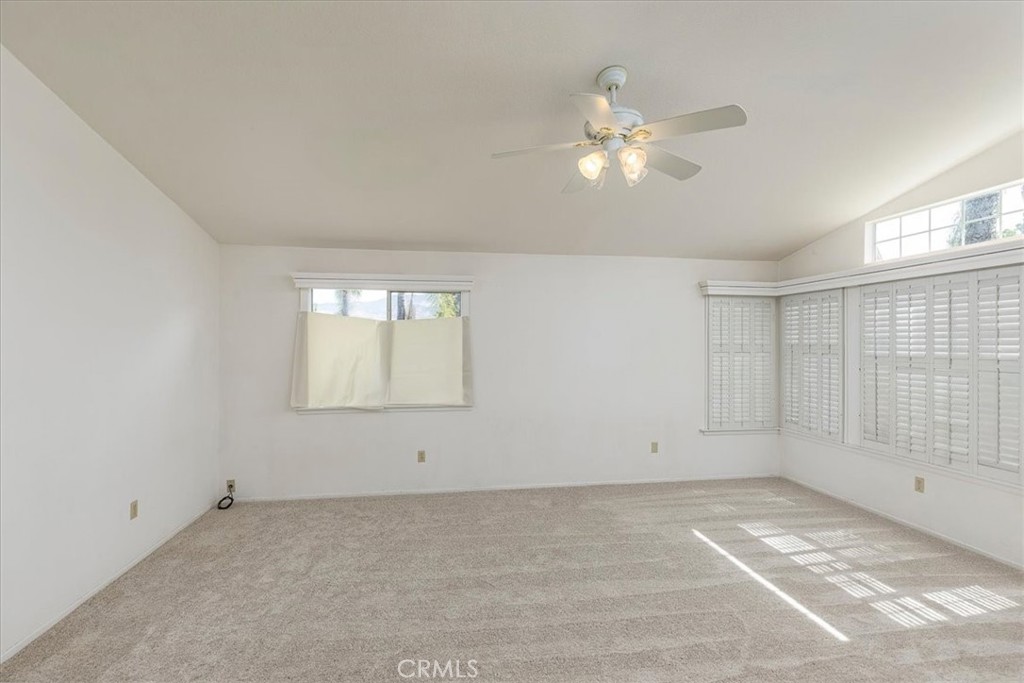 44194 Meadow Grove Street Hemet, CA 92544 - Photo 8 of 42 an empty room with chandelier fan and windows