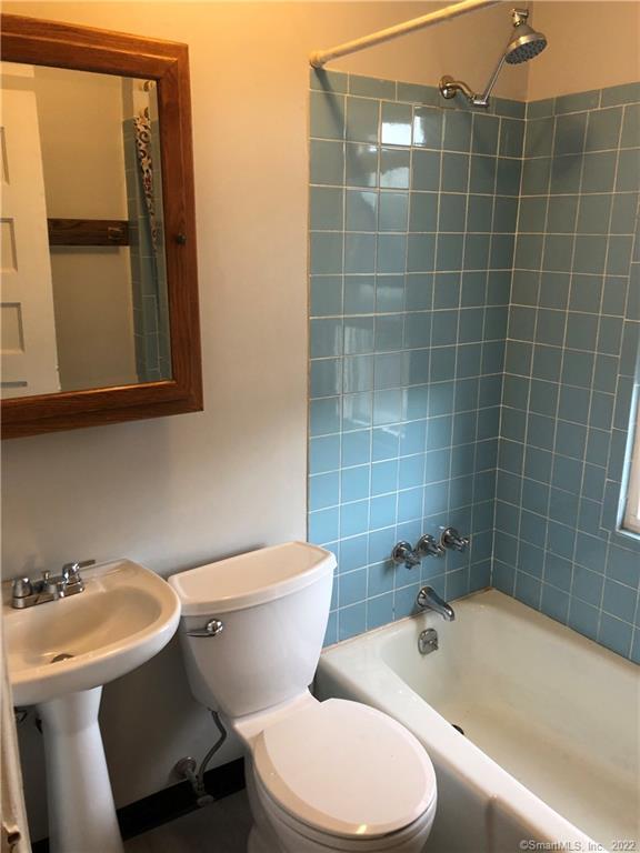 19 Oak Street, Unit 2 New Britain, CT 06051 - Photo 4 of 5 a white toilet sitting next to a bathroom sink and tub