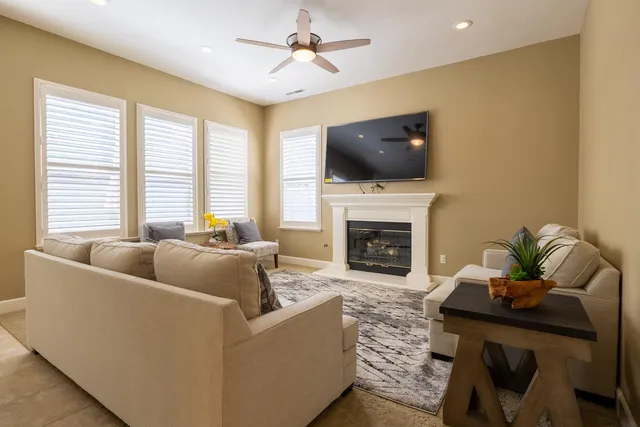 a living room with furniture a fireplace and a flat screen tv