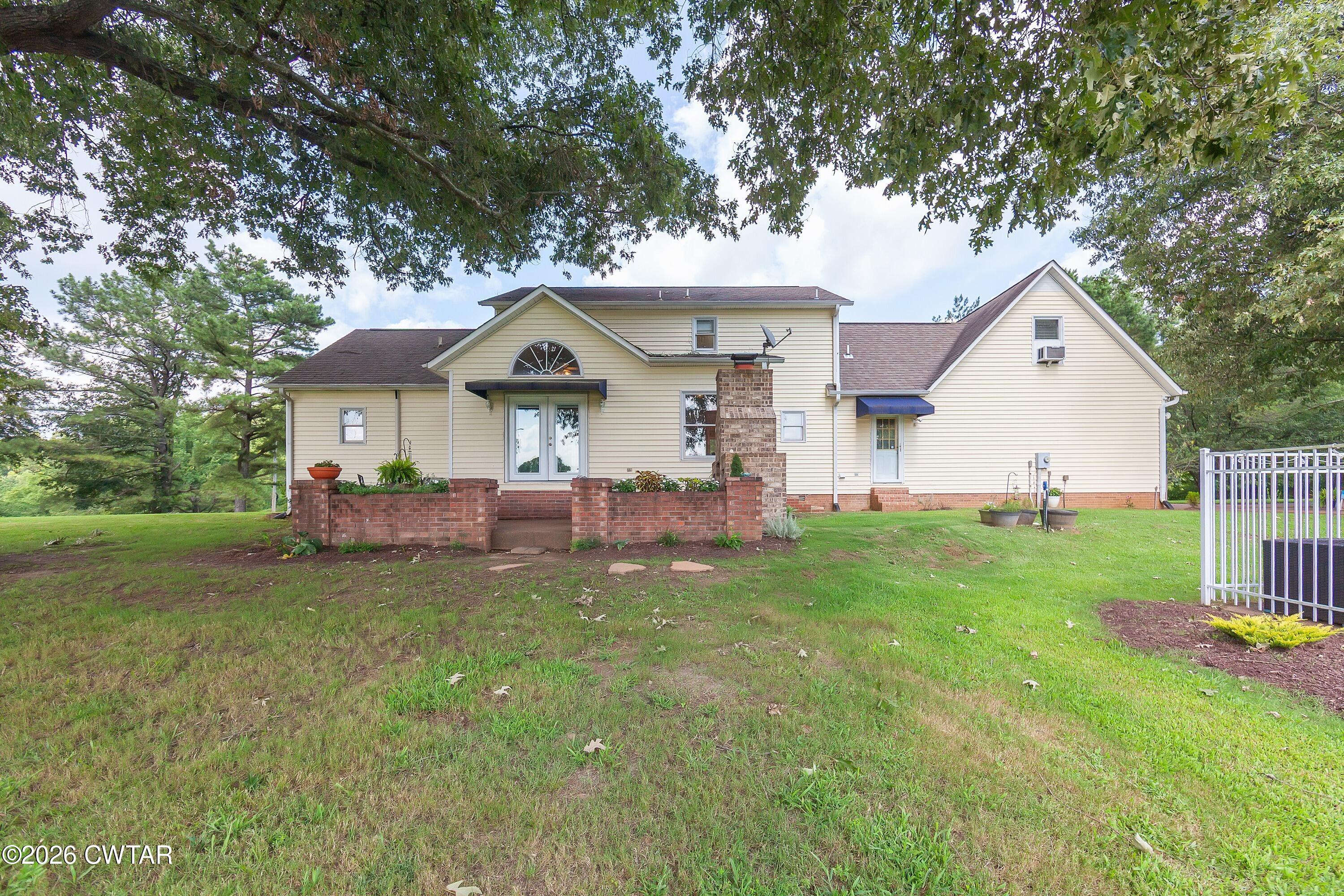 2757 Edward Williams Road Gadsden, TN 38337 - Photo 27 of 57 a front view of a house with a yard and garage