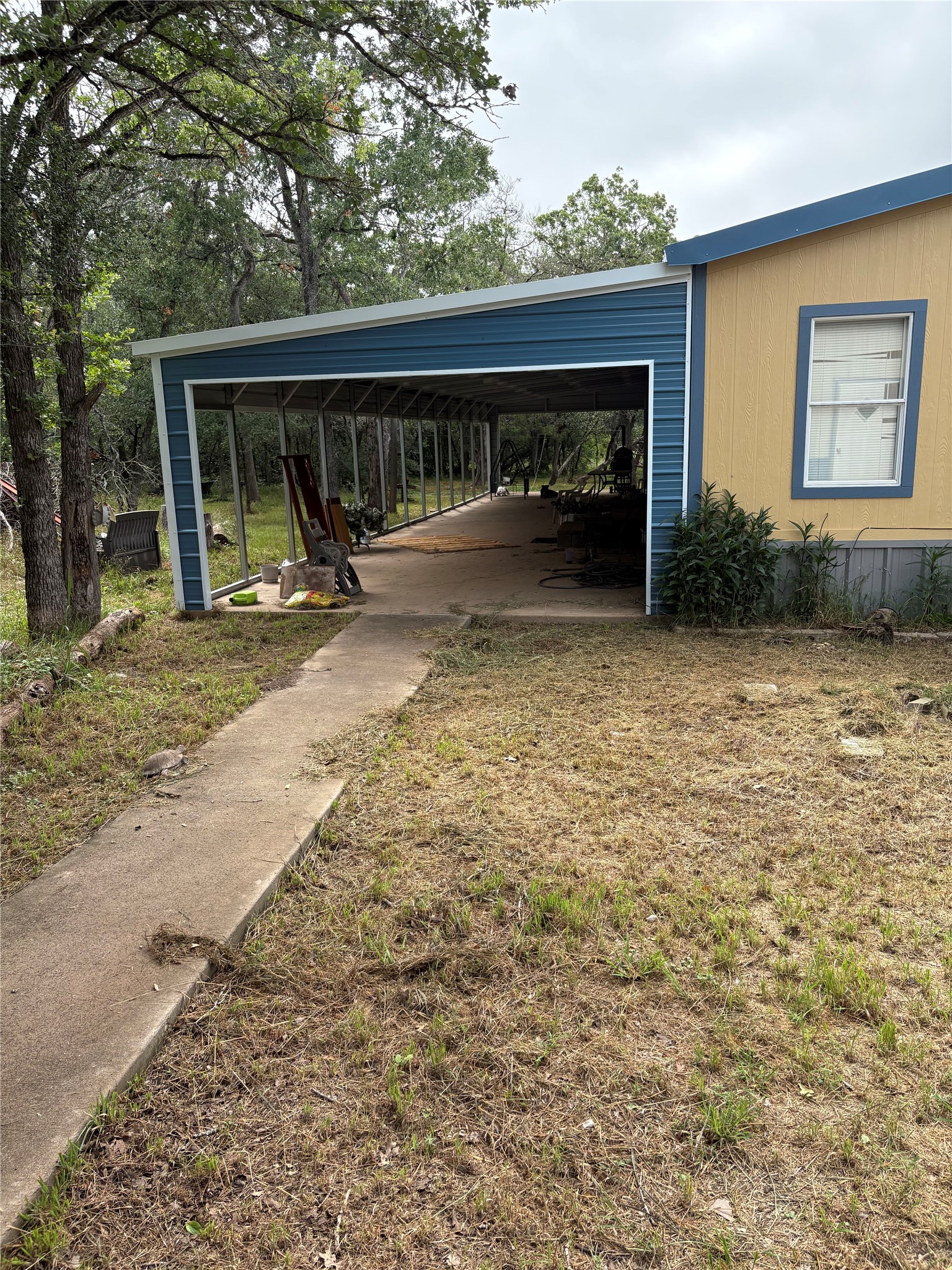 219 High View Ranch Drive Cedar Creek, TX 78612 - Photo 2 of 18 a view of backyard with a patio and a garden