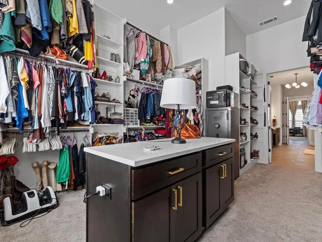 a view of a kitchen with fridge and workspace