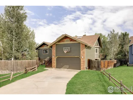 a front view of a house with a garden and yard