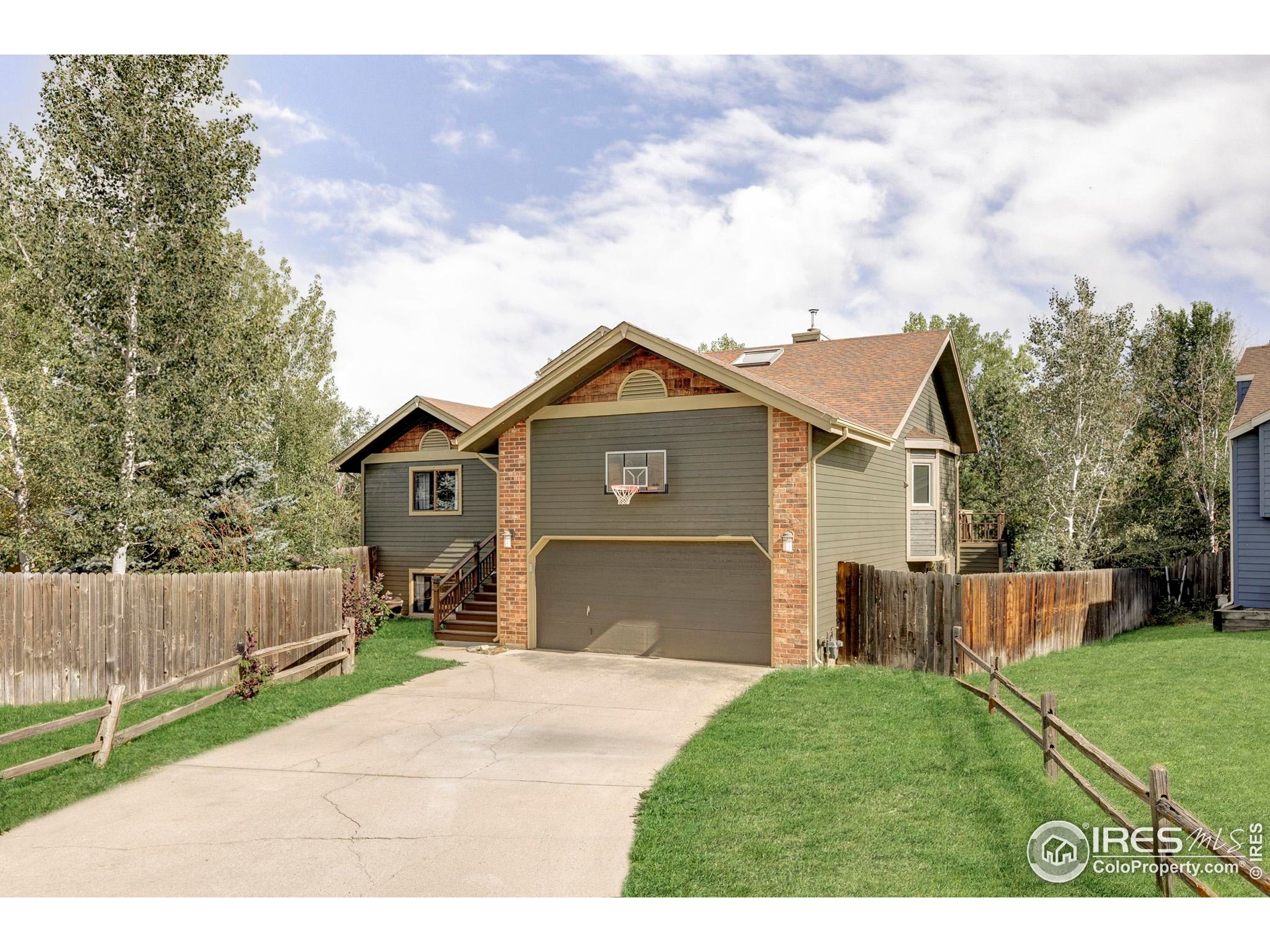 a front view of a house with a garden and yard