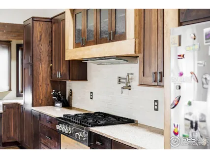 a kitchen with stainless steel appliances a cabinets and a stove top oven