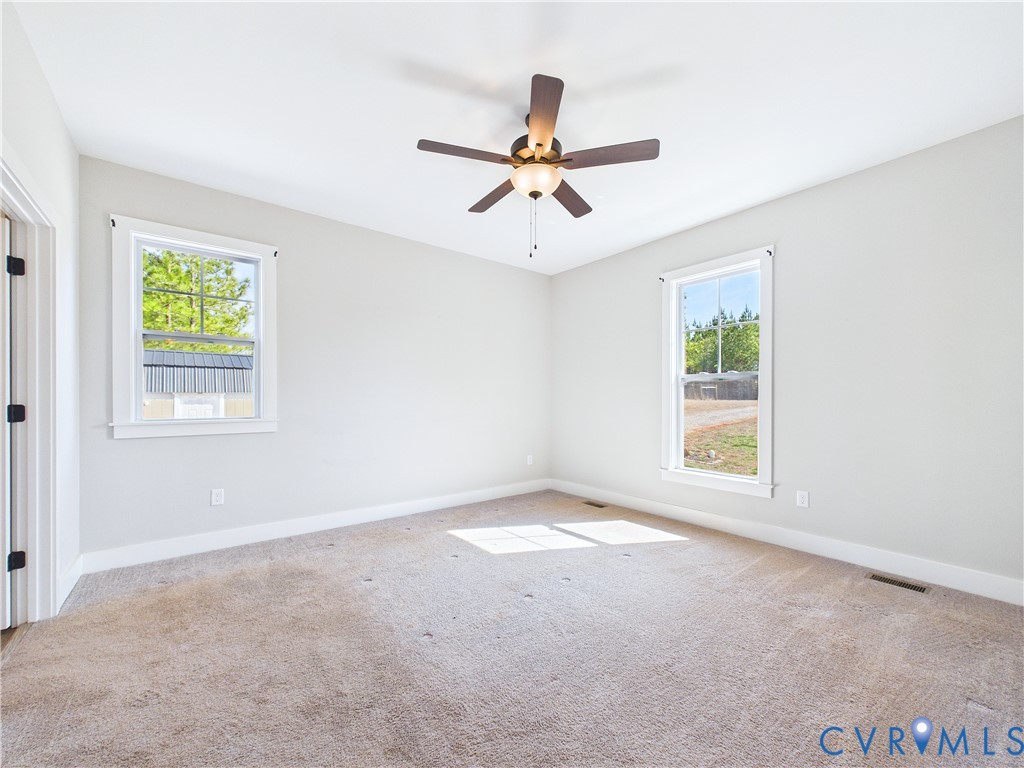 6795 Darlington Heights Road Cullen, VA 23934 - Photo 17 of 44 an empty room with windows and ceiling fan