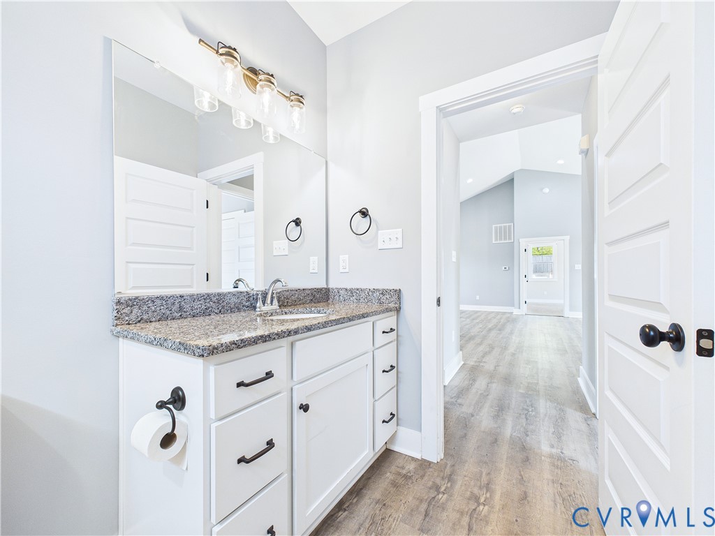 6795 Darlington Heights Road Cullen, VA 23934 - Photo 29 of 44 a spacious bathroom with a granite countertop sink a mirror and shower
