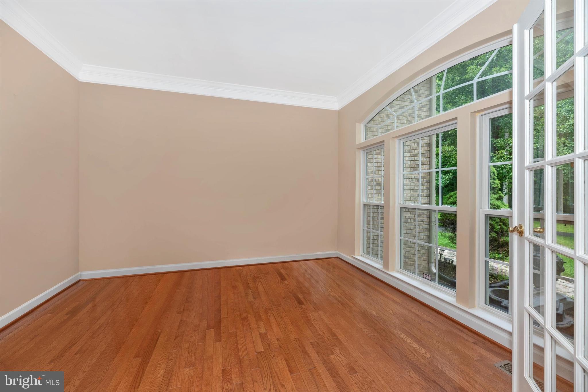 6636 South Clifton Road Frederick, MD 21703 - Photo 13 of 81 an empty room with wooden floor and windows