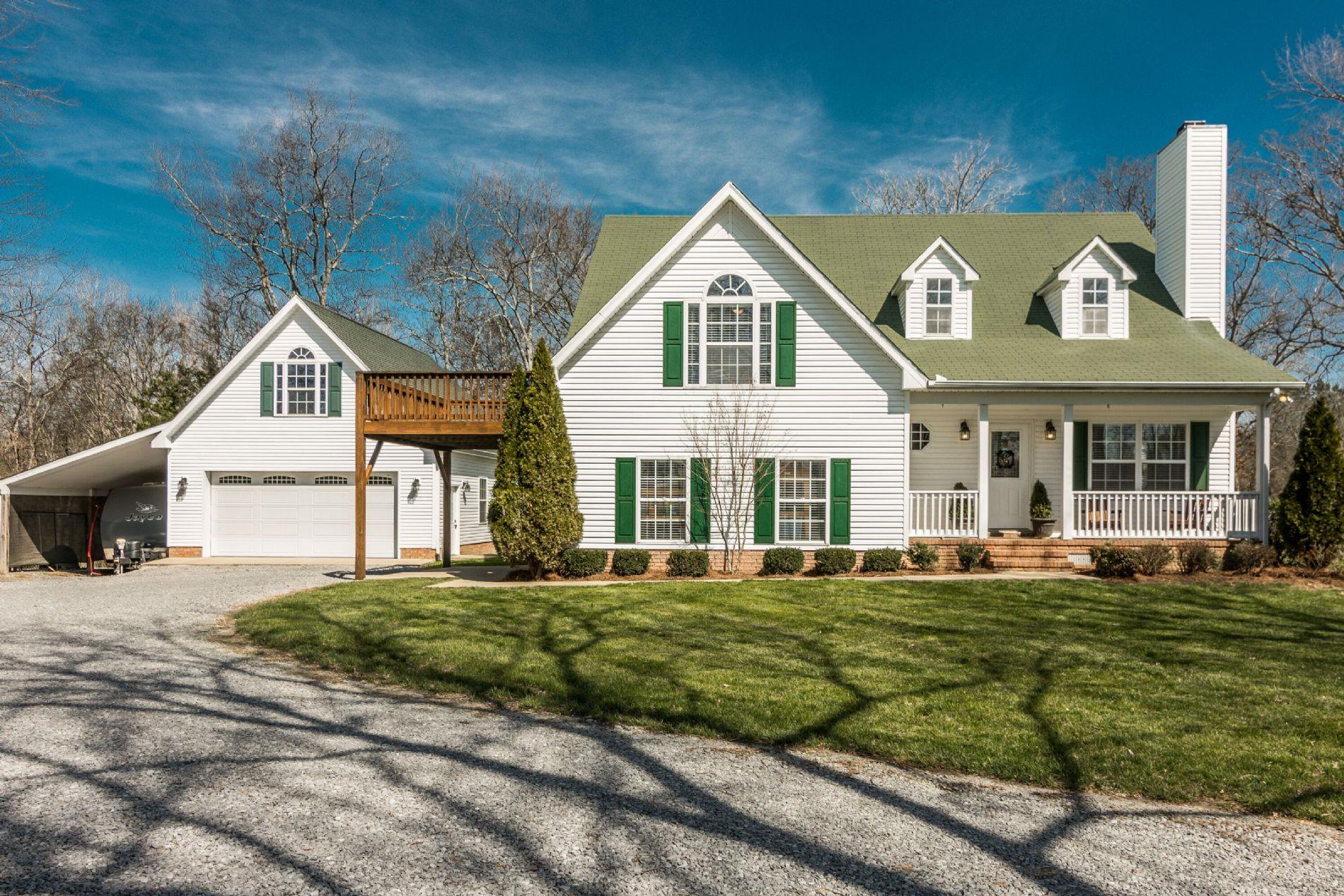 243 Village Green Road Gallatin, TN 37066 - Photo 1 of 24 a front view of a house with a yard