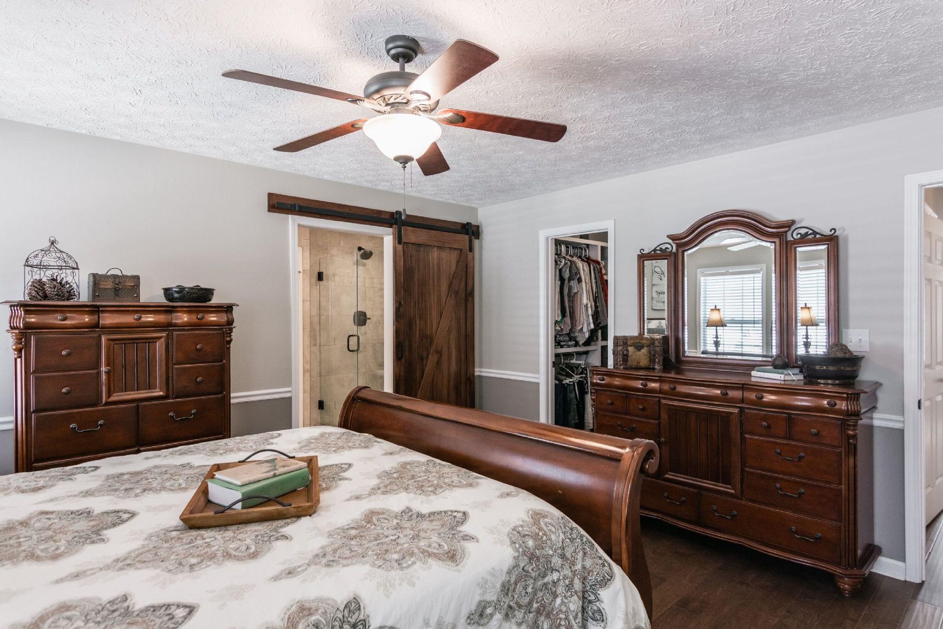 243 Village Green Road Gallatin, TN 37066 - Photo 11 of 24 a bedroom with a bed and a chandelier