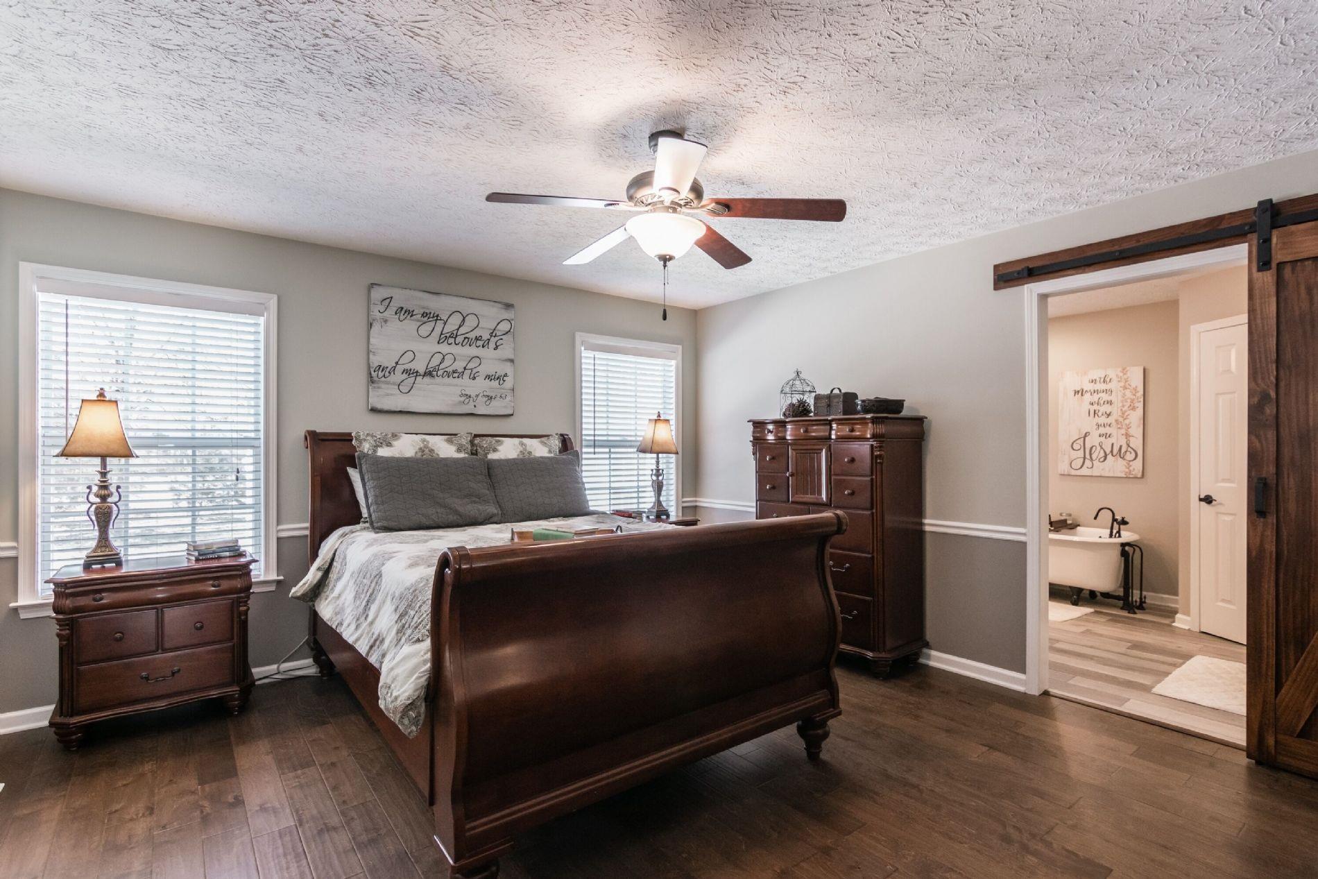 243 Village Green Road Gallatin, TN 37066 - Photo 15 of 24 a bed room with a bed and a chandelier