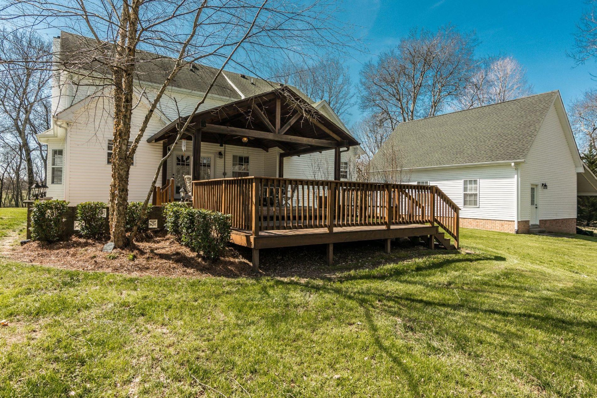 243 Village Green Road Gallatin, TN 37066 - Photo 16 of 24 a view of a backyard with a small cabin