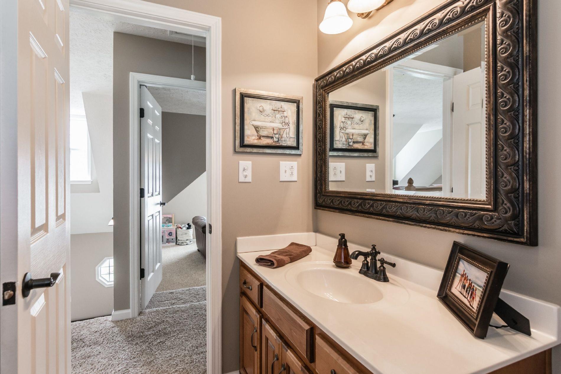 243 Village Green Road Gallatin, TN 37066 - Photo 19 of 24 a bathroom with a sink vanity and mirror