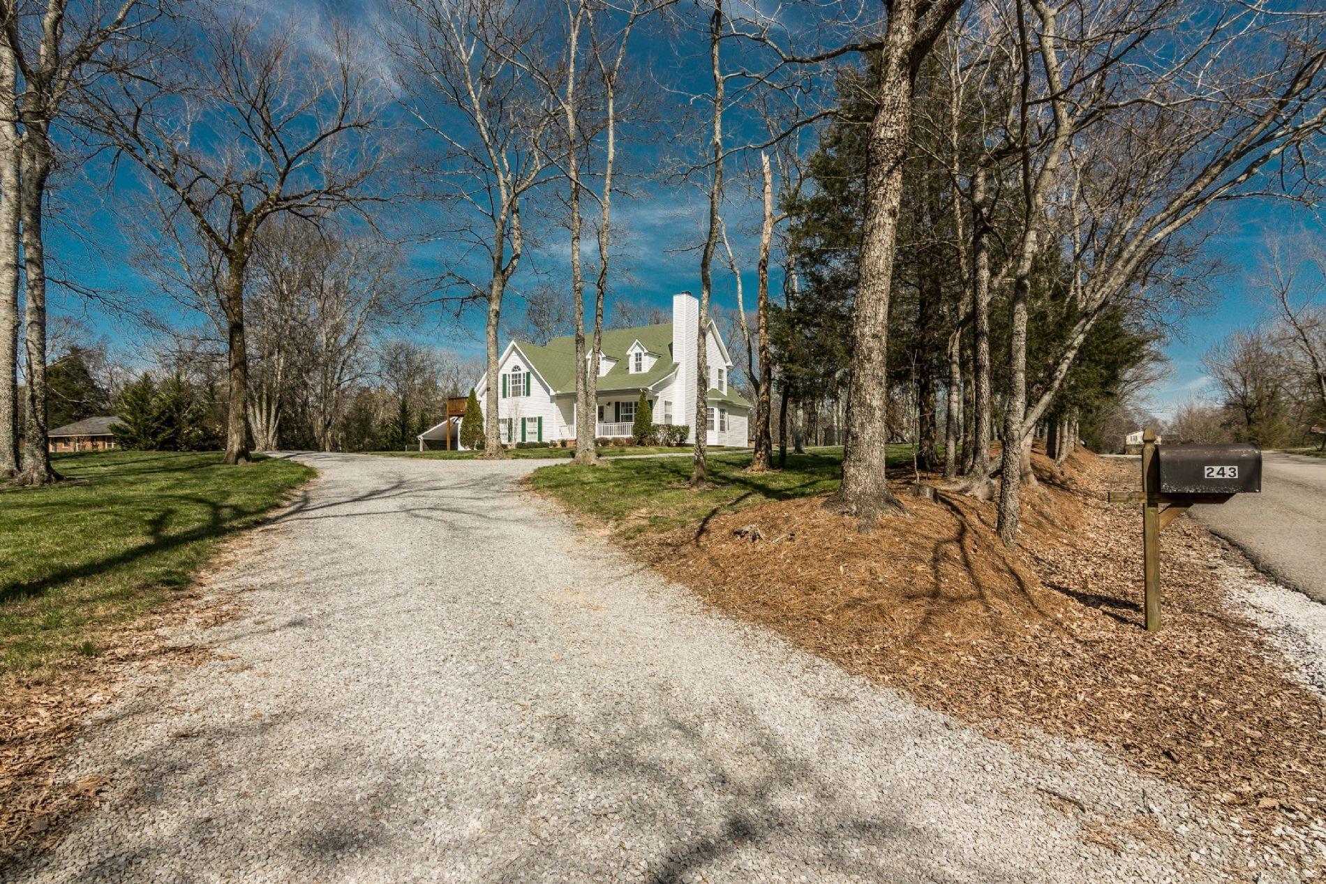 243 Village Green Road Gallatin, TN 37066 - Photo 3 of 24 a view of road with large trees