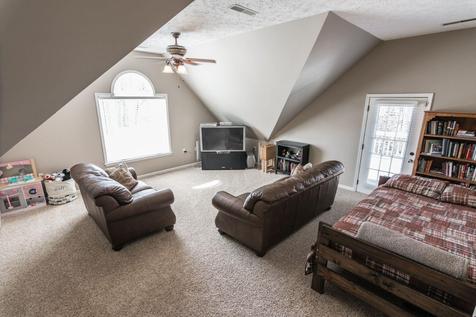243 Village Green Road Gallatin, TN 37066 - Photo 21 of 24 a living room with furniture and a book shelf