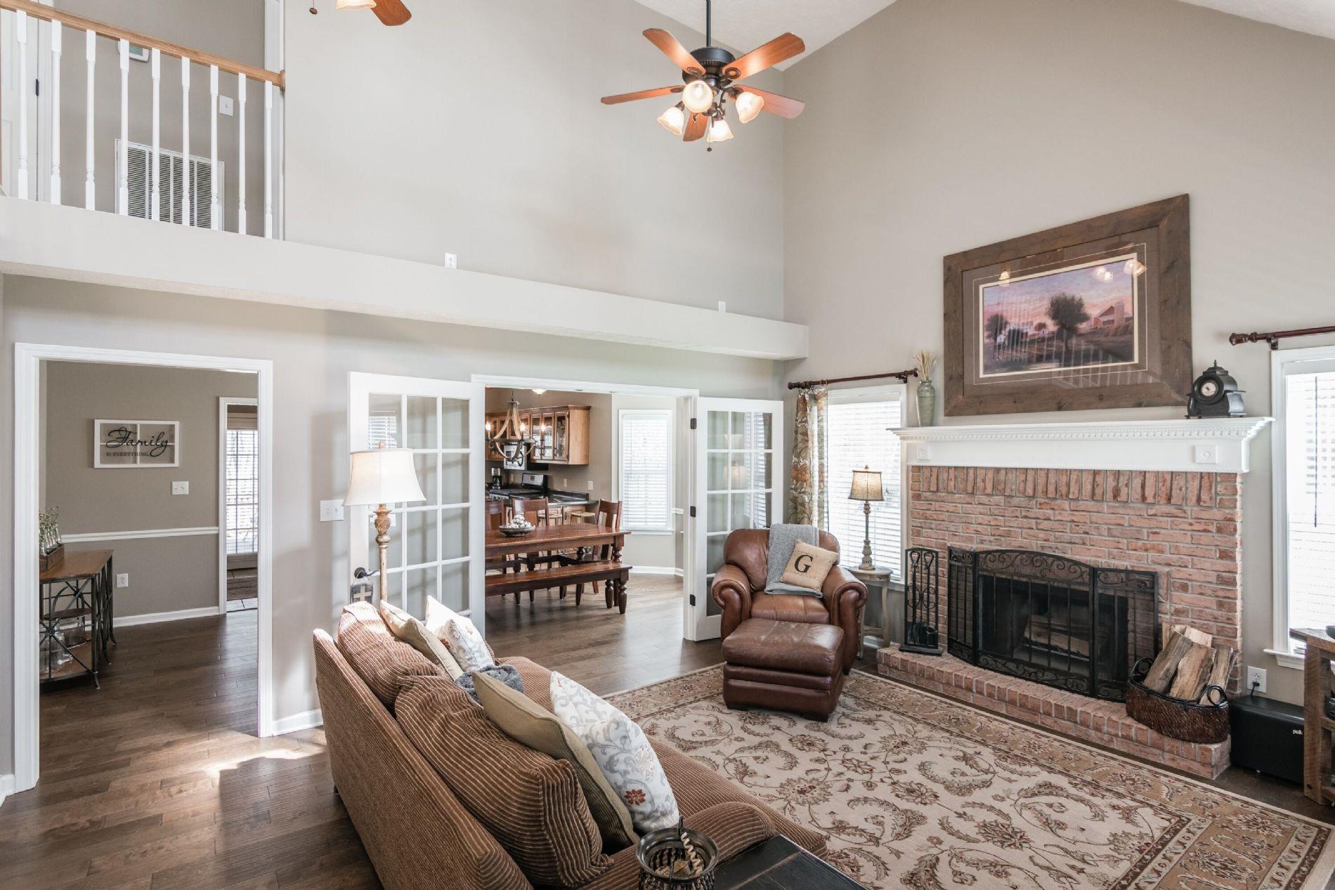 243 Village Green Road Gallatin, TN 37066 - Photo 22 of 24 a living room with furniture a fireplace and a flat screen tv