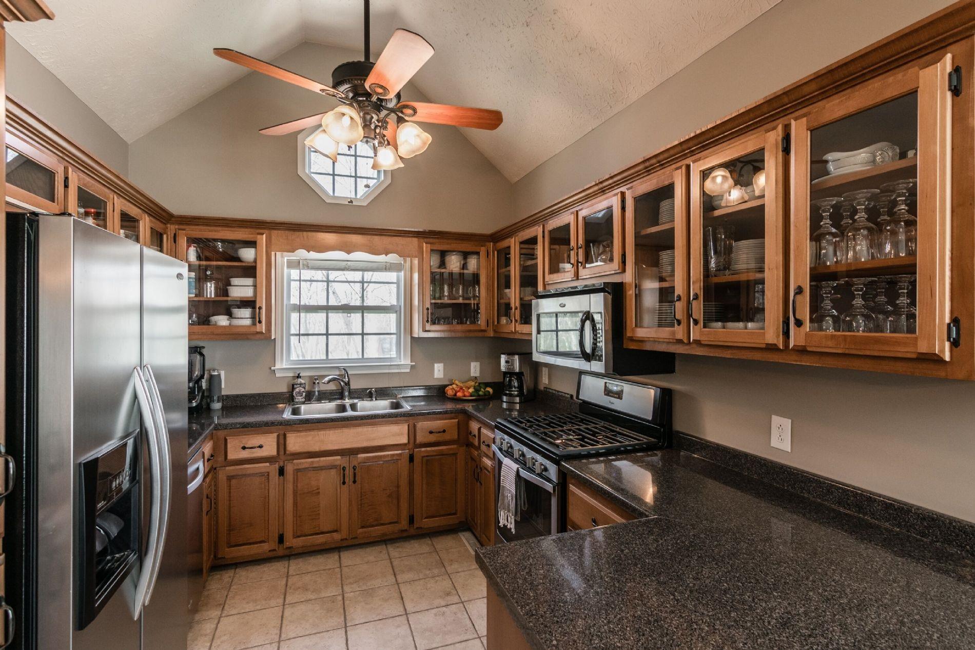243 Village Green Road Gallatin, TN 37066 - Photo 8 of 24 a kitchen with a sink stainless steel appliances and cabinets