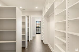 1141 East Lost Ridge Drive Washington, UT 84780 - Photo 45 of 108 Hallway featuring extensive built-in white shelving, recessed lighting, wood-finish flooring, and a black-framed glass door