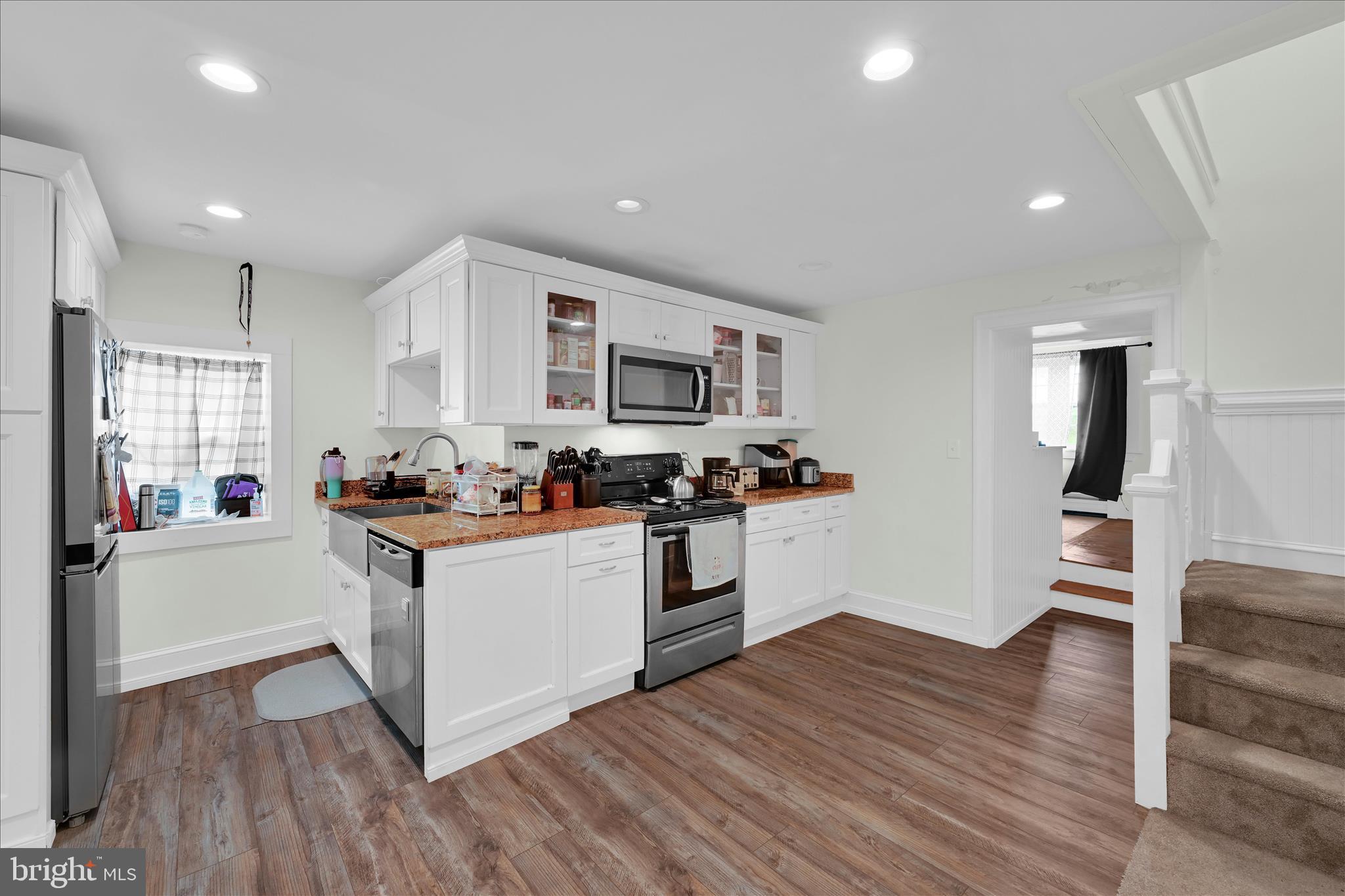 286 Schuylkill Road Birdsboro, PA 19508 - Photo 16 of 39 a kitchen with wooden floors and white appliances