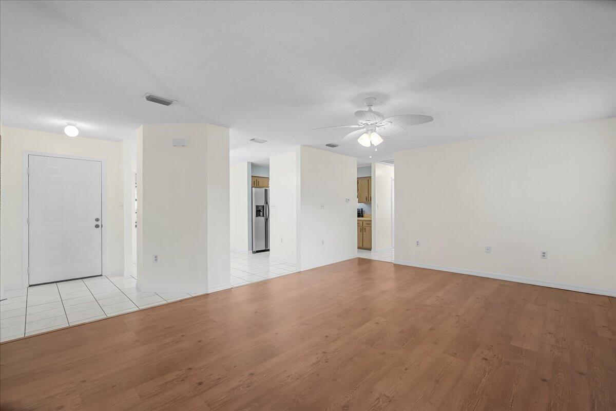 4514 Seattle Street Cocoa, FL 32927 - Photo 12 of 34 a view of an empty room with a ceiling fan
