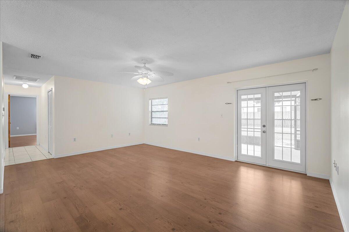 4514 Seattle Street Cocoa, FL 32927 - Photo 13 of 34 wooden floor in an empty room with a window