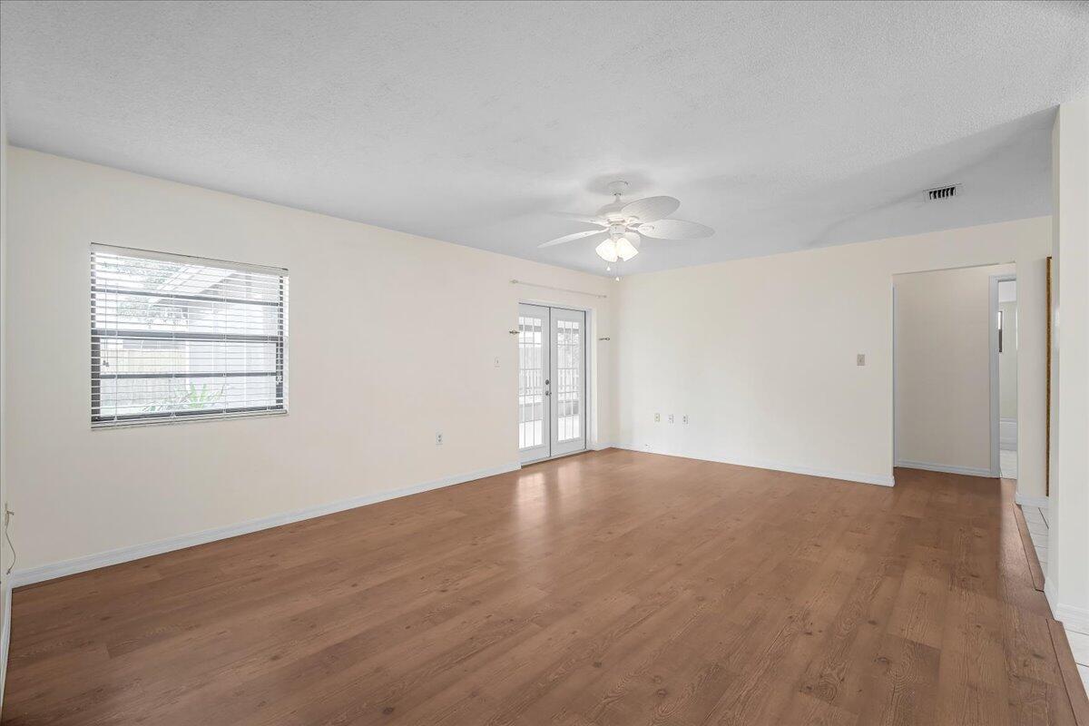 4514 Seattle Street Cocoa, FL 32927 - Photo 14 of 34 a view of an empty room with chandelier fan and fire place