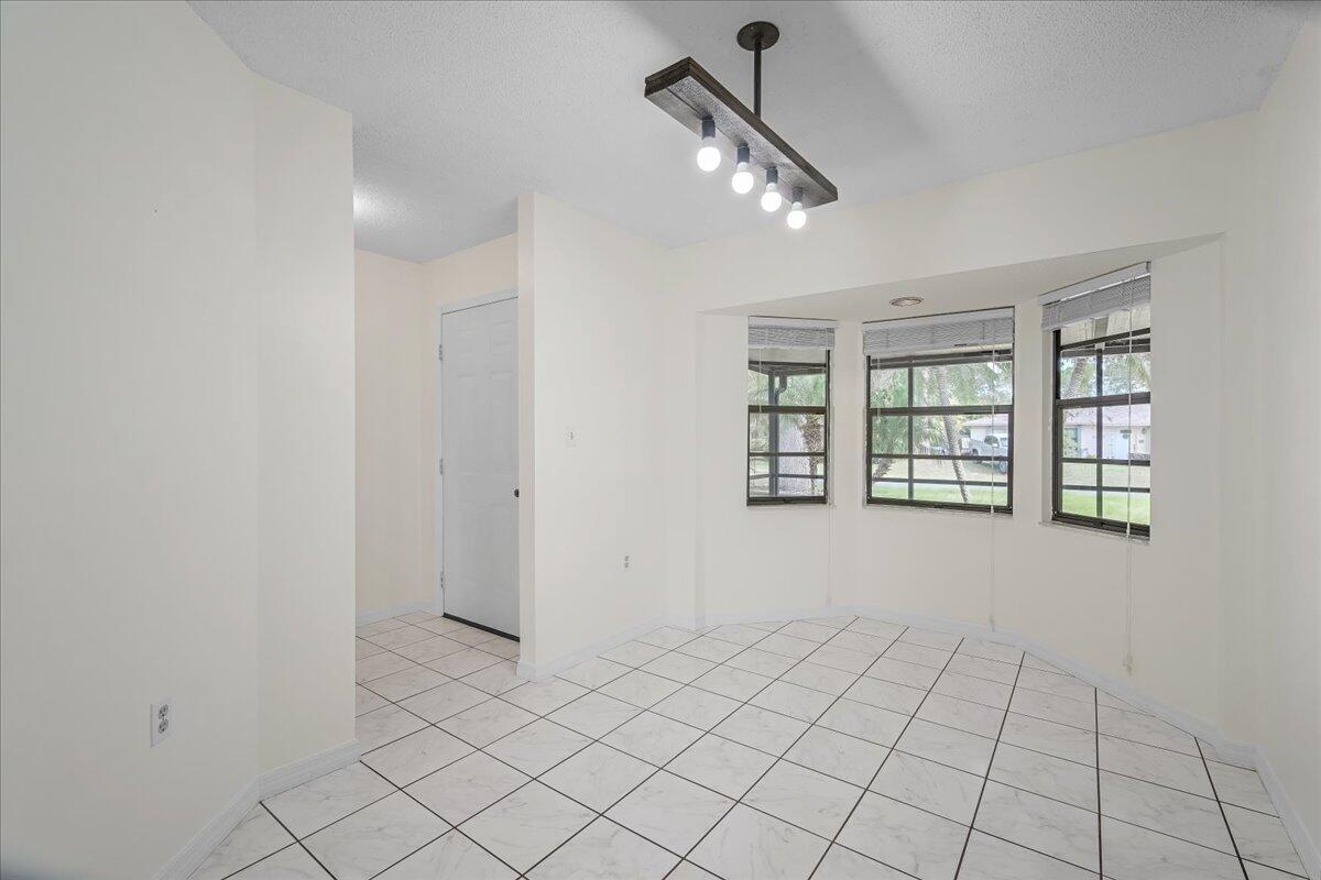 4514 Seattle Street Cocoa, FL 32927 - Photo 15 of 34 wooden floor in an empty room with a window