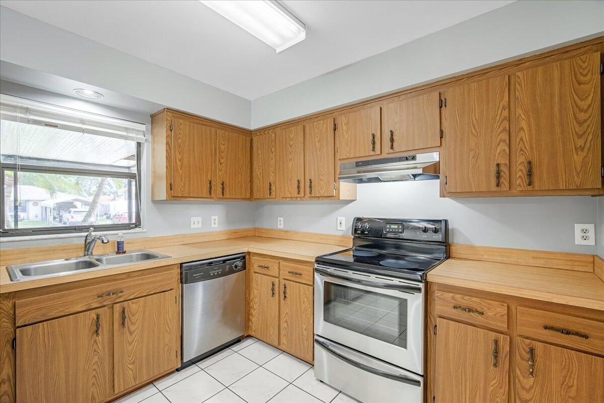 4514 Seattle Street Cocoa, FL 32927 - Photo 19 of 34 a kitchen with cabinets appliances and a window