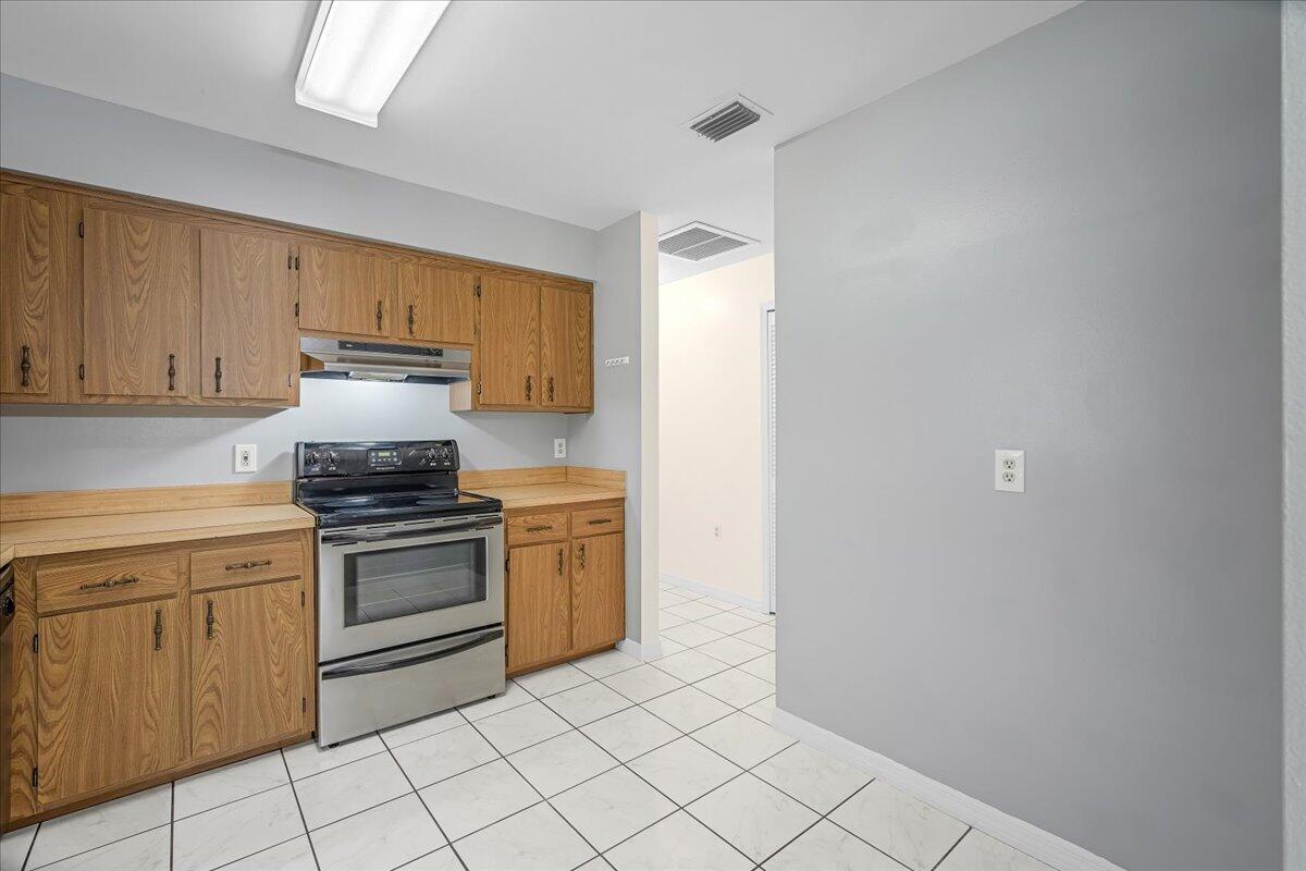 4514 Seattle Street Cocoa, FL 32927 - Photo 20 of 34 a kitchen with a stove top oven and sink