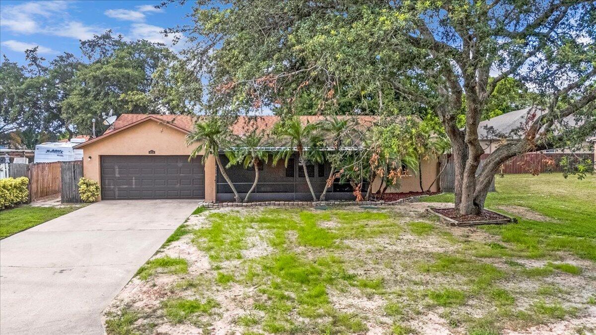 4514 Seattle Street Cocoa, FL 32927 - Photo 2 of 34 a front view of a house with a yard and garage