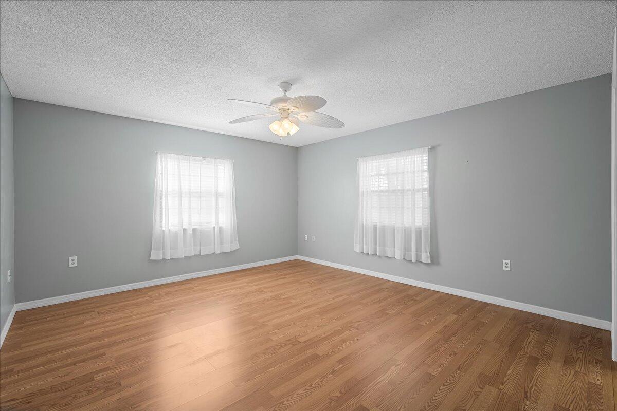 4514 Seattle Street Cocoa, FL 32927 - Photo 21 of 34 a view of an empty room with a window and wooden floor