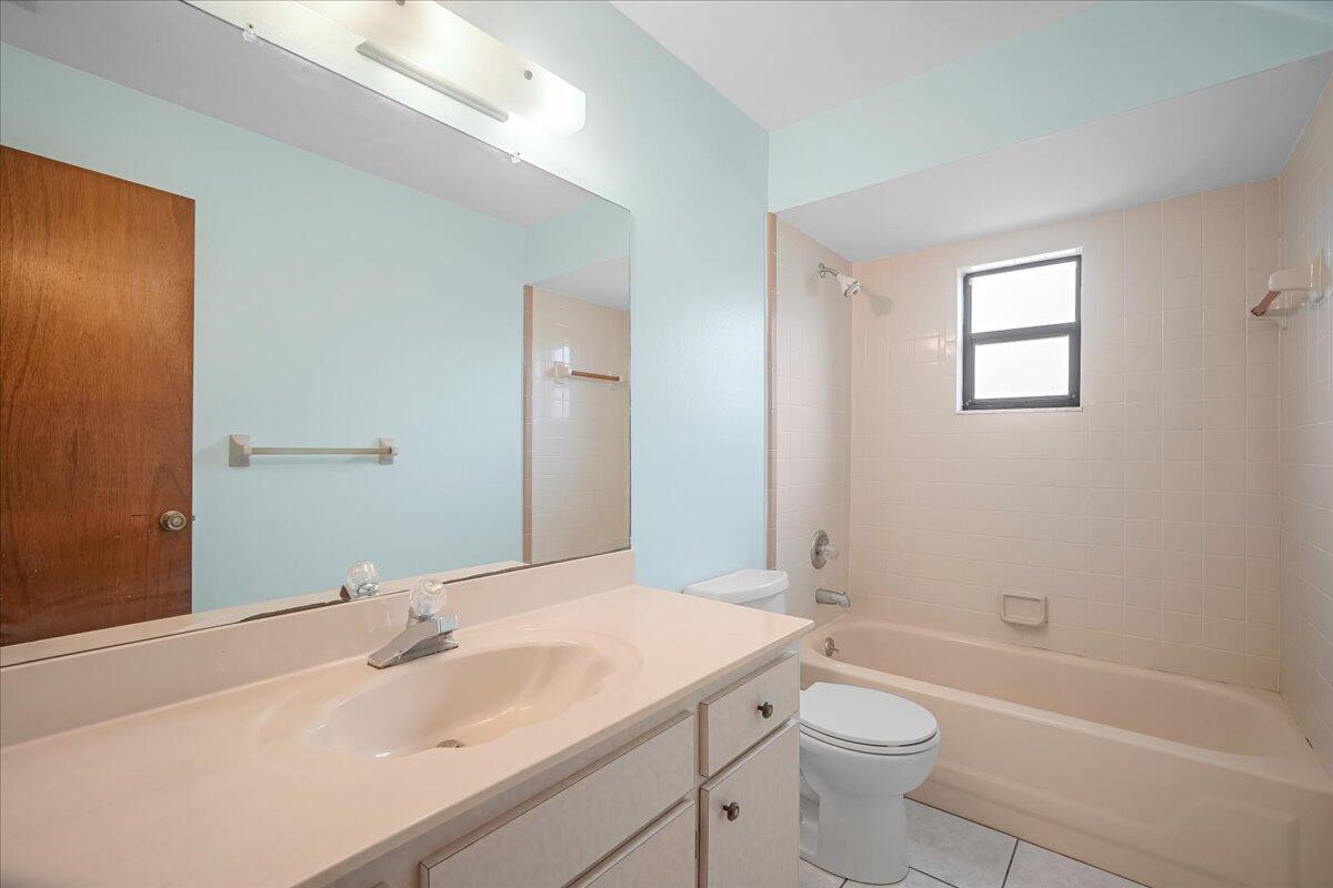 4514 Seattle Street Cocoa, FL 32927 - Photo 26 of 34 a bathroom with a sink a toilet and shower