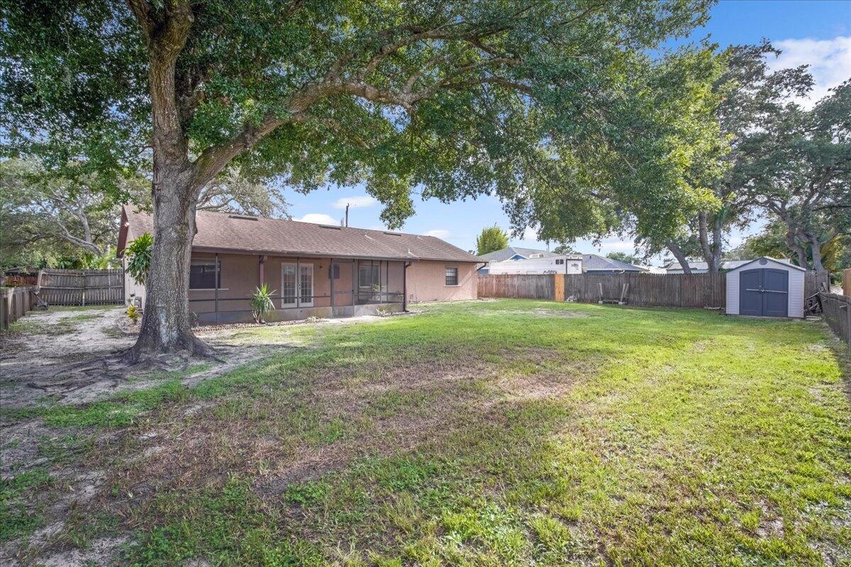 4514 Seattle Street Cocoa, FL 32927 - Photo 30 of 34 a view of a house with a yard and a large tree