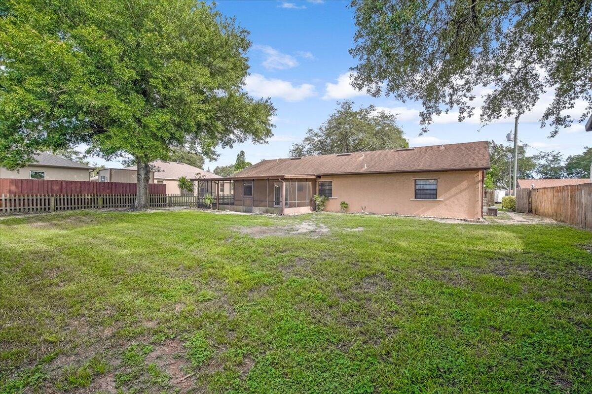 4514 Seattle Street Cocoa, FL 32927 - Photo 31 of 34 a front view of house with yard and trees