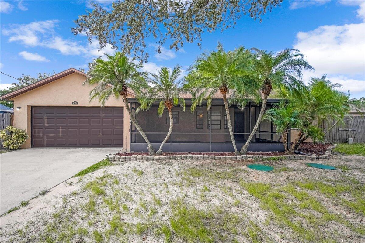 4514 Seattle Street Cocoa, FL 32927 - Photo 6 of 34 a house with palm tree in front of it