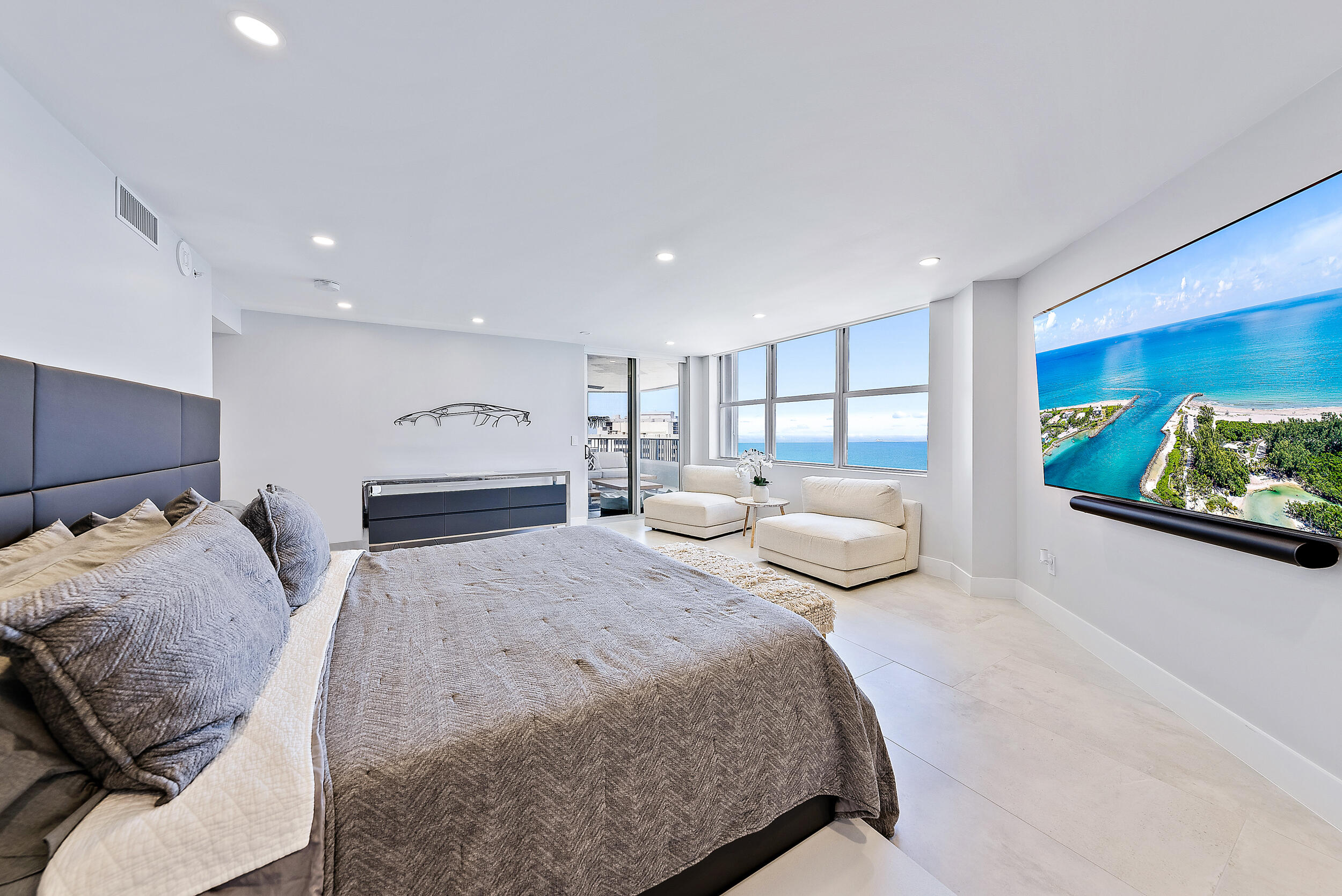 5200 North Ocean Drive, Unit 2003 Singer Island, FL 33404 - Photo 13 of 40 a bedroom with a bed and glass walk in closet