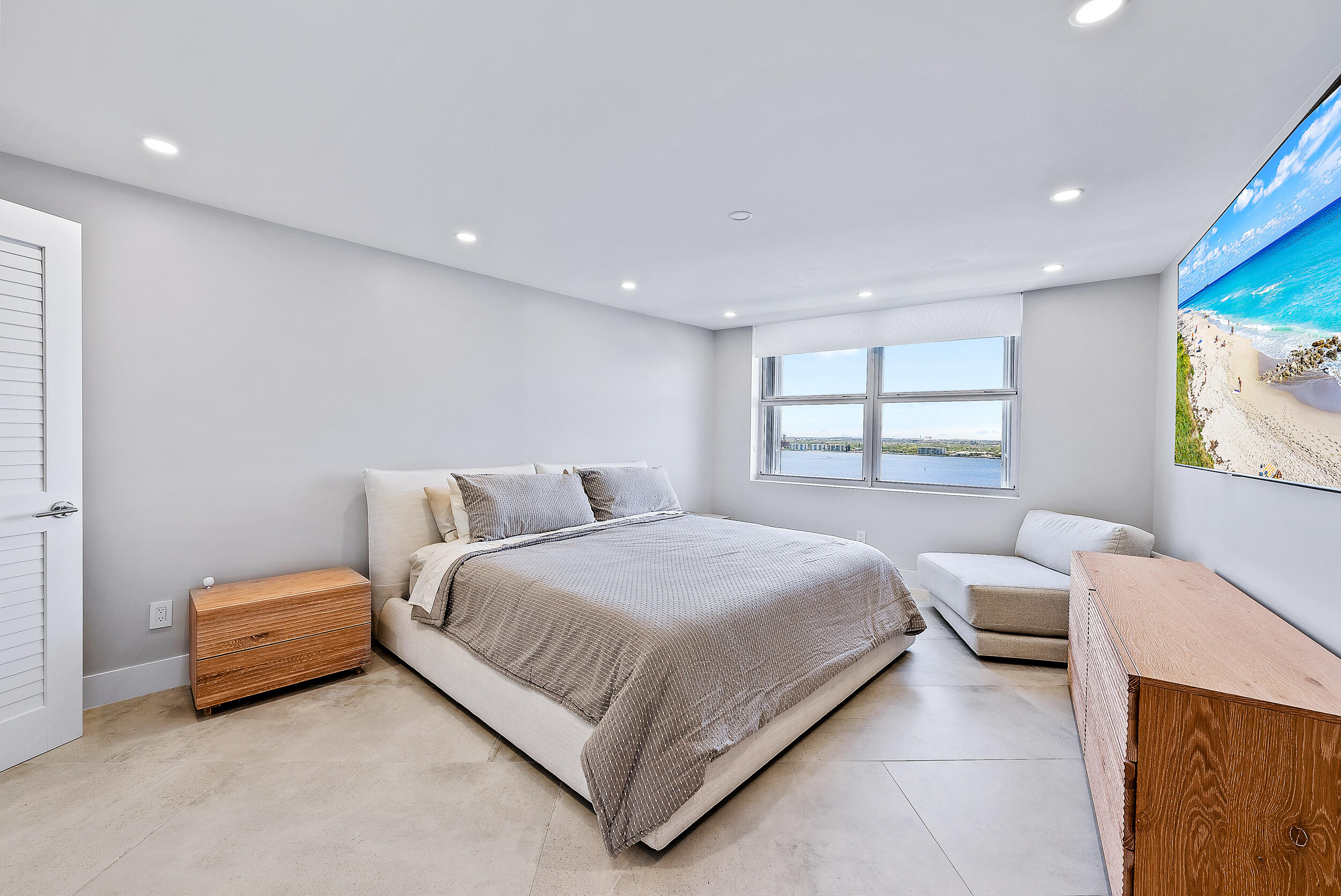 5200 North Ocean Drive, Unit 2003 Singer Island, FL 33404 - Photo 20 of 40 a bedroom with a bed and a large window